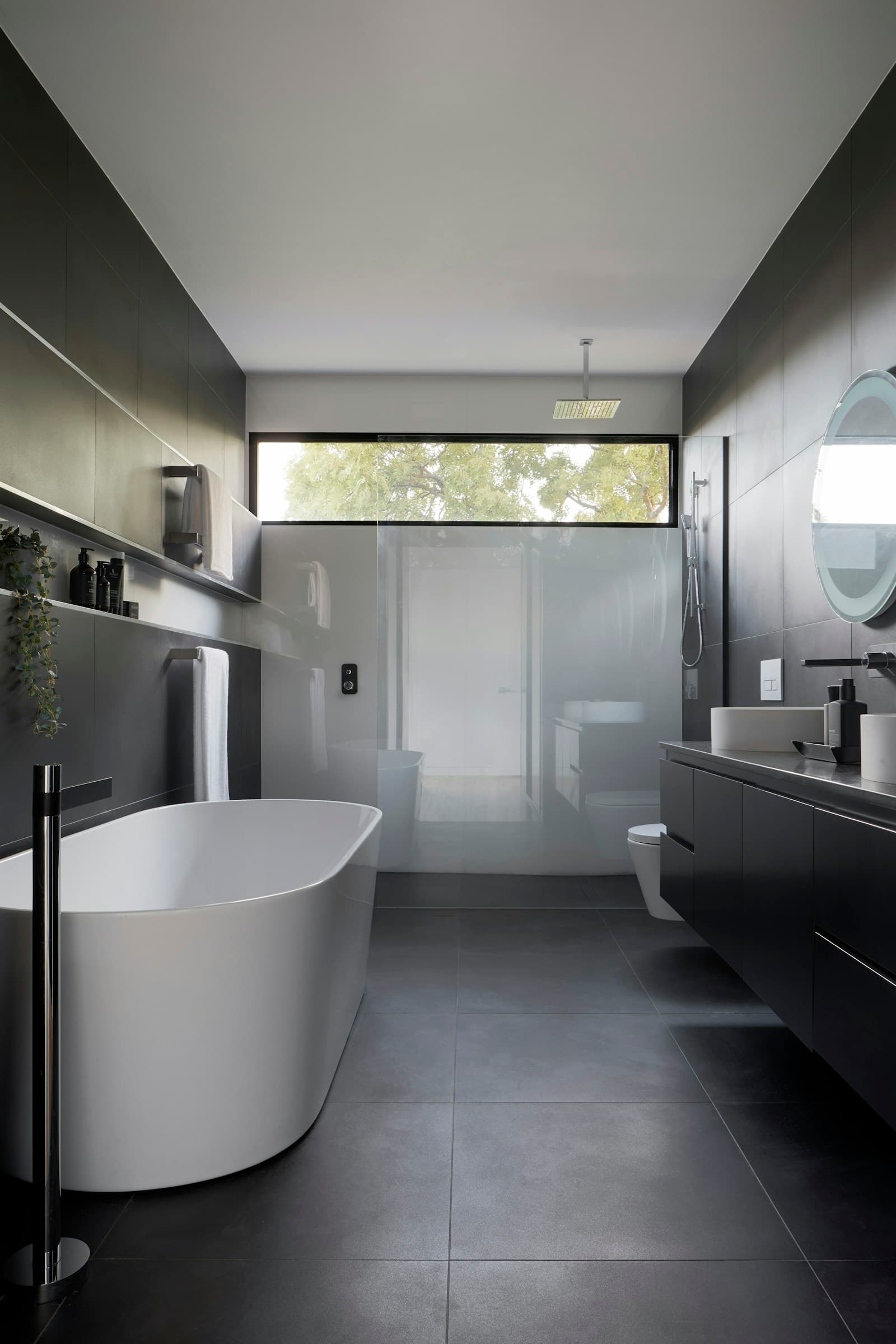 A contemporary bathroom with warm daylight and considered materials